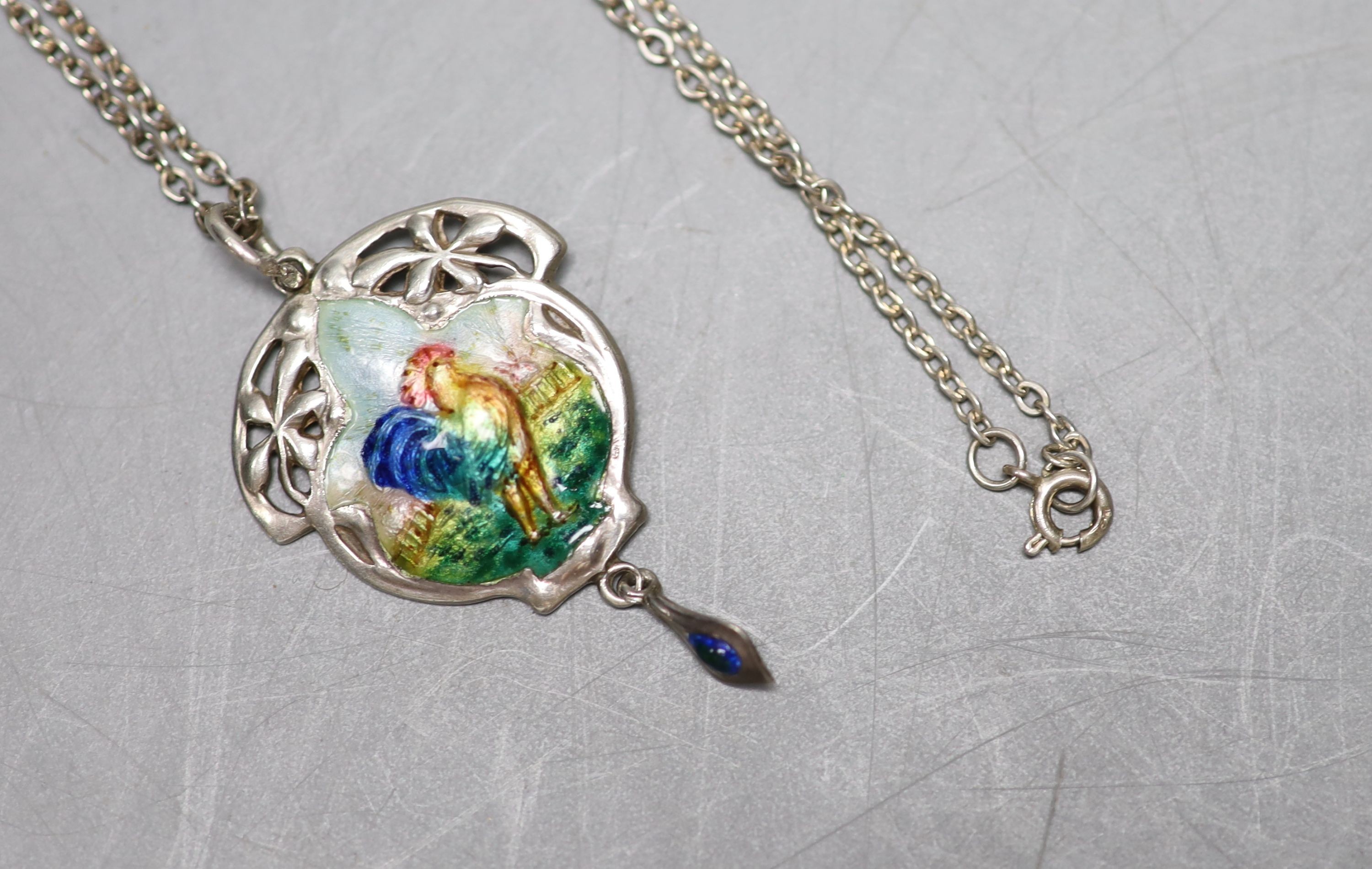 An Edwardian Art Nouveau silver and polychrome enamel set drop pendant, Birmingham, 1909, 43mm, on a white metal chain.